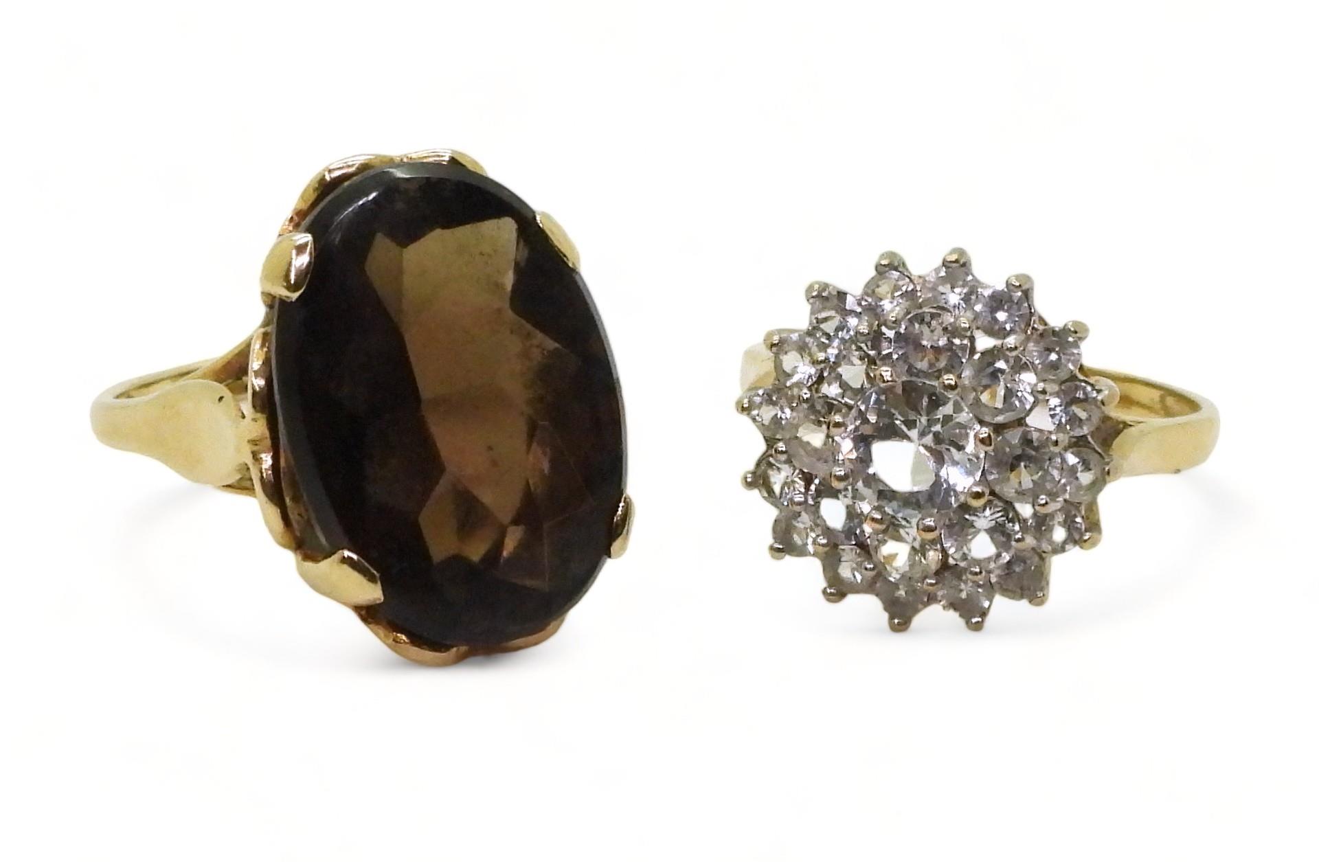 A 9ct gold smoky quartz ring, hallmarked London 1963, size K, and a clear gem set cluster, size O,