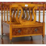 A 20th century yew wood Canterbury with four lyre shaped dividers over single drawer on turned