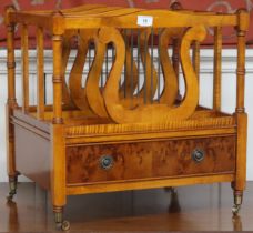 A 20th century yew wood Canterbury with four lyre shaped dividers over single drawer on turned