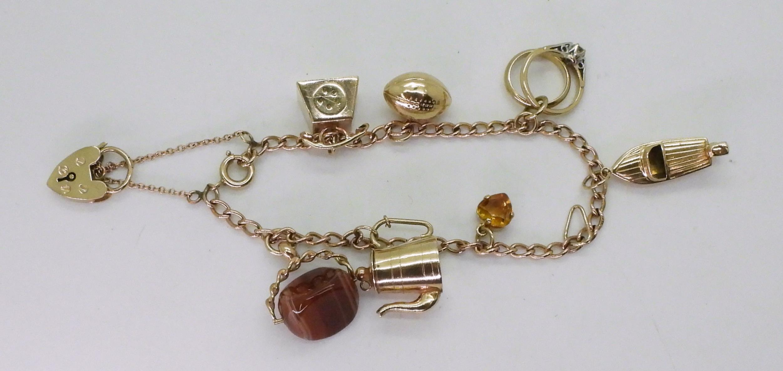 A 9ct gold charm bracelet with seven attached 9ct gold and yellow metal charms to include a speed - Image 3 of 3
