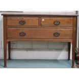 An early 20th century oak dressing chest with two short over one long drawers with stylized copper