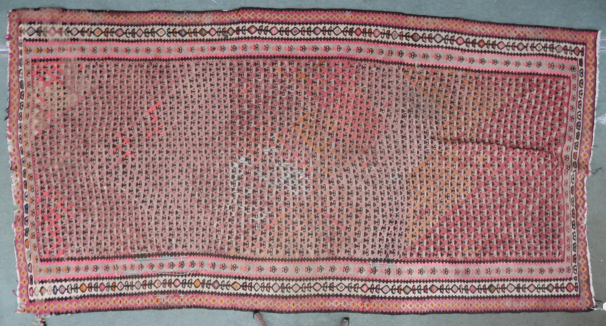 A pink ground Malayer runner with multicoloured borders, 260cm long x 134cm wide Condition Report: