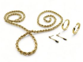 A 9ct gold rope chain, length 77cm, a pair of 9ct gold hoop earrings, and a pair of yellow metal