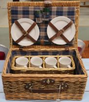 A 20th century wicker picnic hamper with cups and plates Condition Report:Available upon request