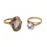 A 9ct gold smoky quartz ring, stamped Zeeta, finger size M, and a clear gem set solitaire, size L1/