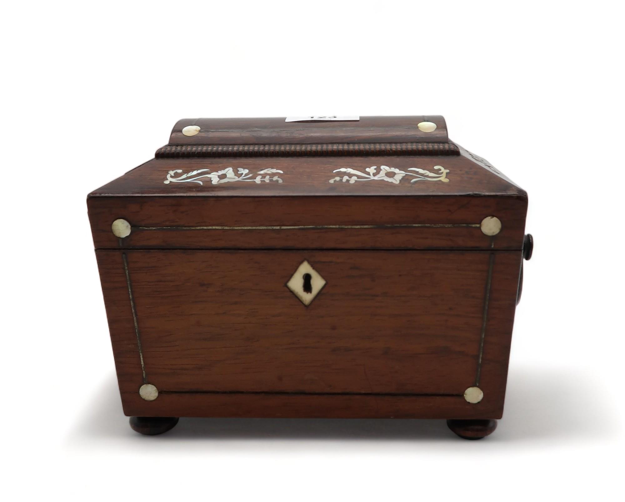 A Regency style mother of pearl inlaid tea caddy of casket shape with ring handles and two