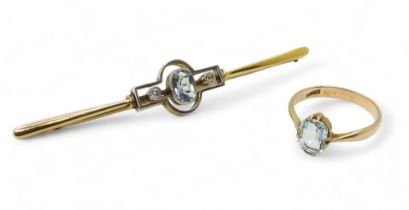 A bright yellow metal and white metal bar brooch set with an aquamarine and two diamonds totaling