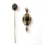 A Victorian yellow metal pendant set with a Bull's eye agate, with black and white Greek key and bud