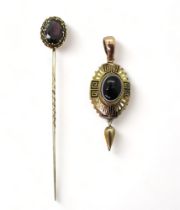 A Victorian yellow metal pendant set with a Bull's eye agate, with black and white Greek key and bud