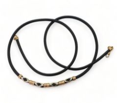 A rubber necklet with 14ct gold clasp and 14ct rose and white gold beaded detail, weight 8.2gms