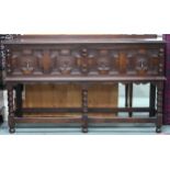 A 20th century oak Jacobean style two drawer buffet table on turned supports joined by stretchers,