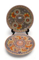 A Charlotte Rhead for Crown Ducal charger, tube lined with Art Deco style decoration of flowers in