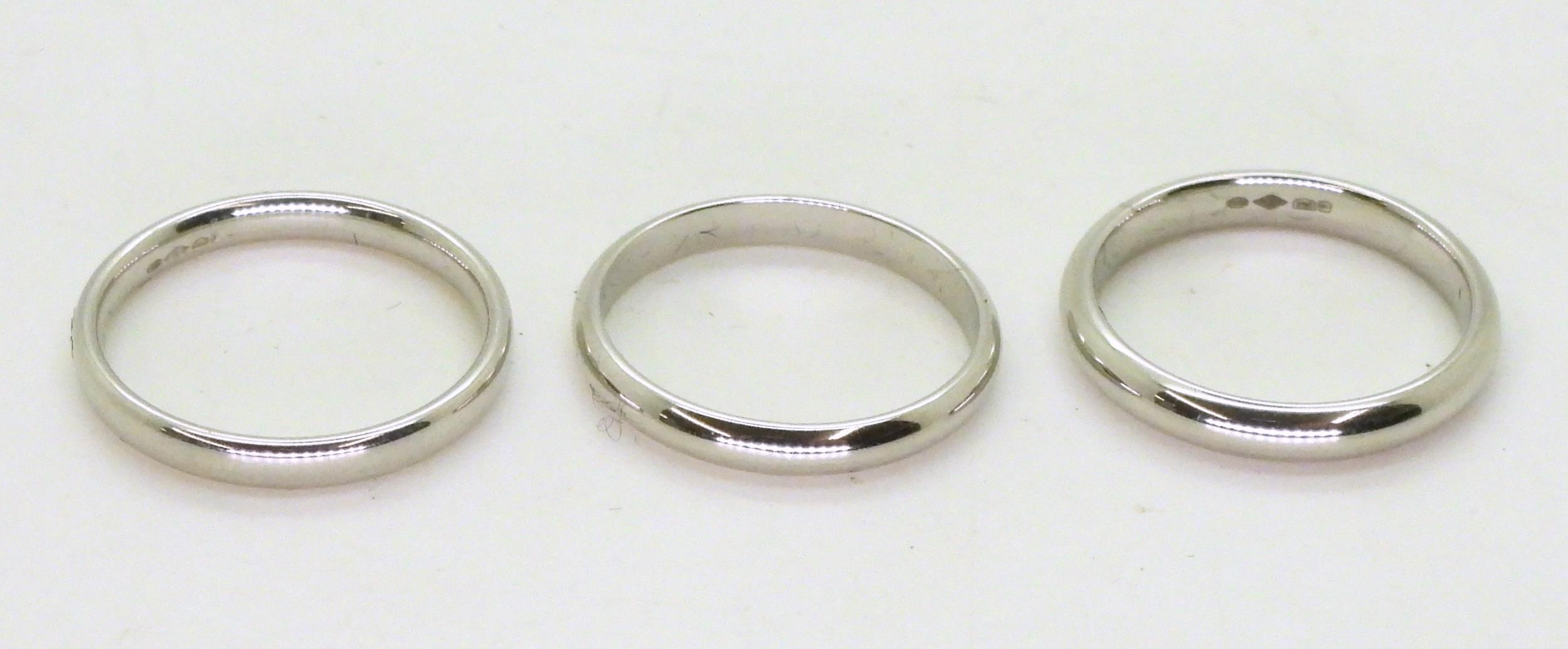 Three platinum wedding bands, Size two are L1/2, one L, weight together 10.8gms Condition Report: - Image 2 of 4
