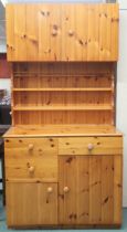 A 20th century pine estate built kitchen cabinet with pair of cabinet doors over open plate rack