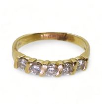 A bright yellow metal five stone diamond ring, set with estimated approx 0.50cts of brilliant cut
