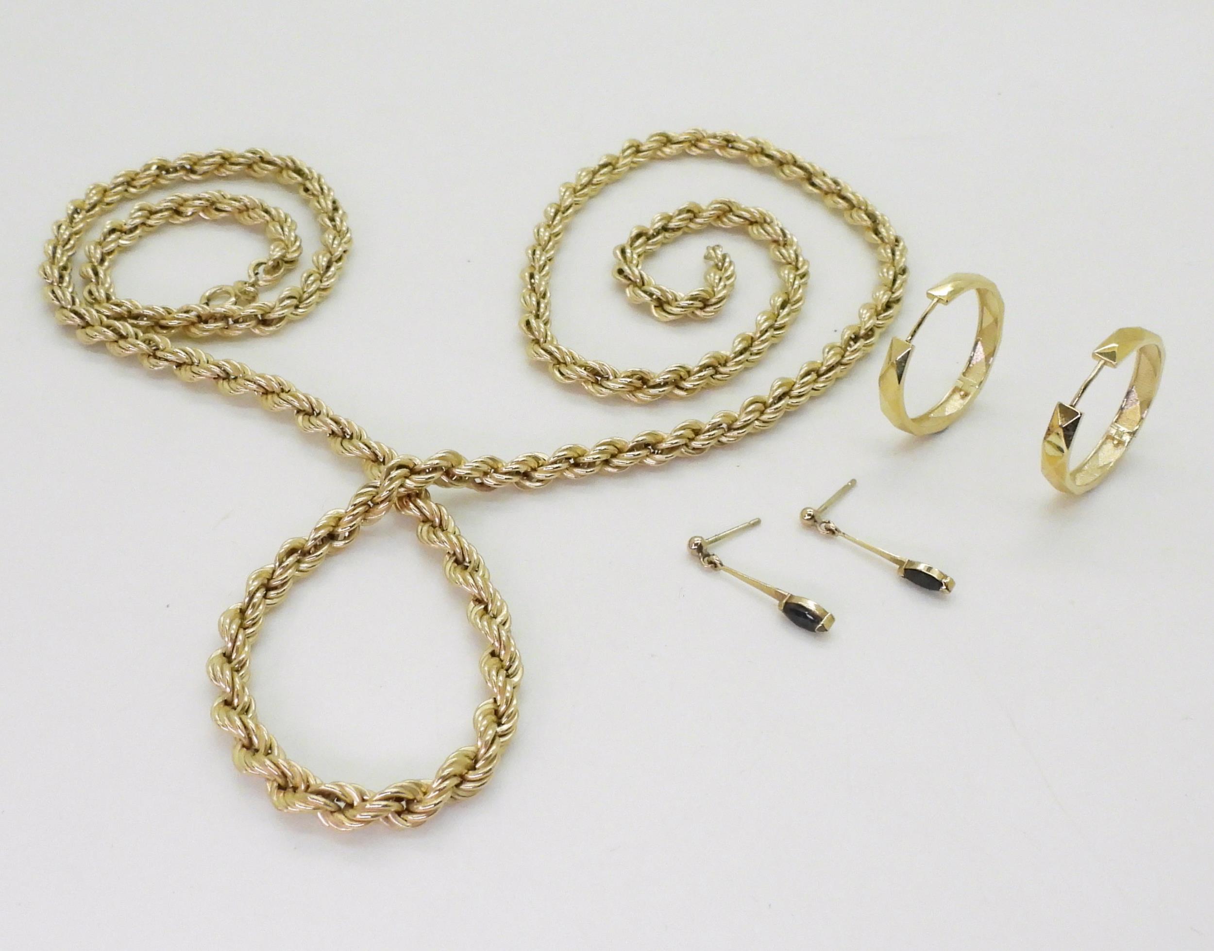 A 9ct gold rope chain, length 77cm, a pair of 9ct gold hoop earrings, and a pair of yellow metal - Image 2 of 2