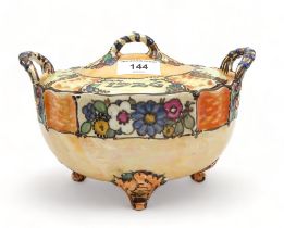 Ann Macbeth (1875-1948)  - A two handled lidded dish, painted with flowers, initials F.M and dated