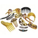 A collection of decorative hair combs in horn and early plastic together with hair slides to include