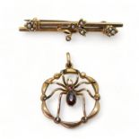 A 9ct gold garnet set spider pendant, diameter 2.2cm and a 9ct gold brooch, weight together 4gms