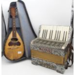 An Alvari 24 bass 25 key piano accordion together with a Sicilian flat back mandolin by Afredo