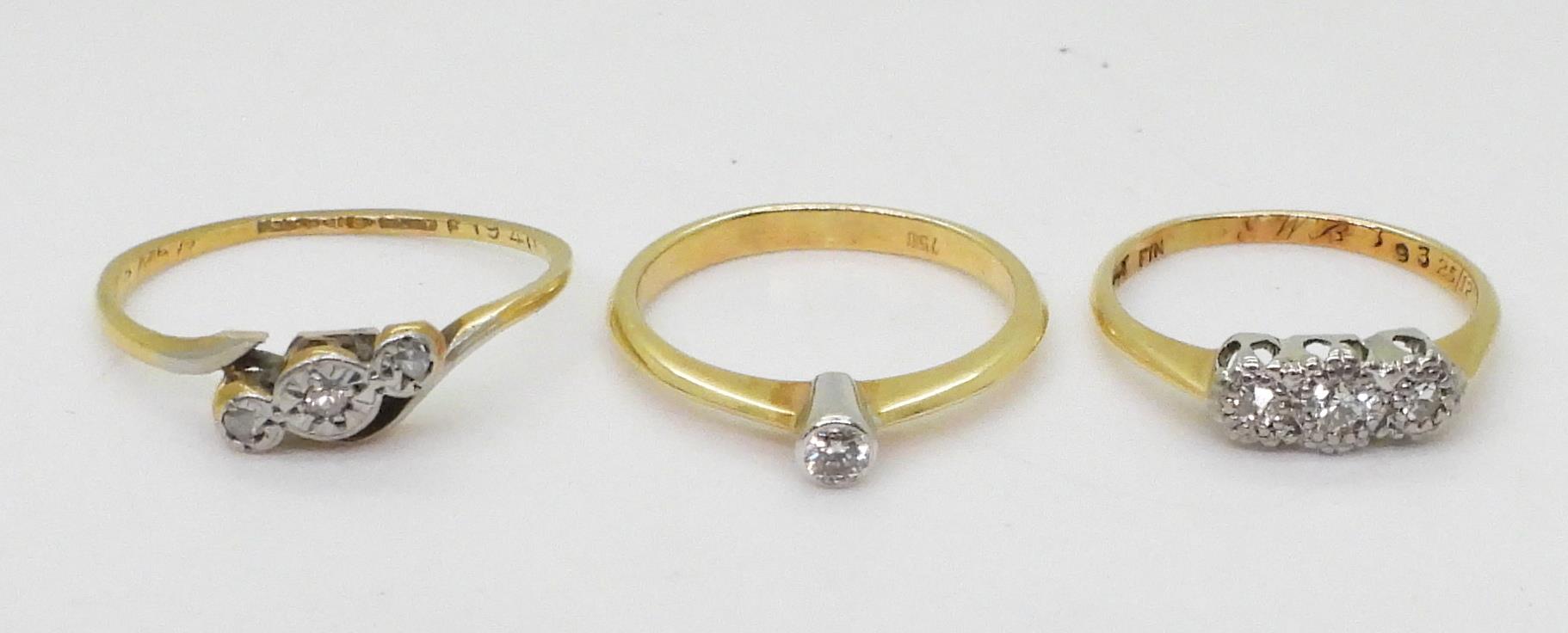 Three 18ct diamond rings, a 0.06ct solitaire size K, a illusion set three stone, size J, and a ( - Image 2 of 3