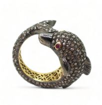 A yellow and white metal dolphin ring completely pave set with rose cut diamonds, with ruby set