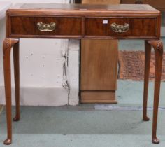 A 20th century walnut veneered ladies writing desk with embossed skiver over two drawers on cabriole