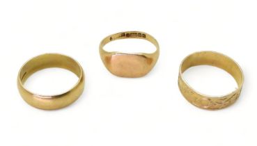 Two 9ct gold wedding rings, sizes Q1/2 and N and a signet ring, size O1/2, weight together 9.2gms