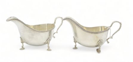A pair of silver sauceboats, by Mappin & Webb, Sheffield 1957, with an anthemion-capped scroll