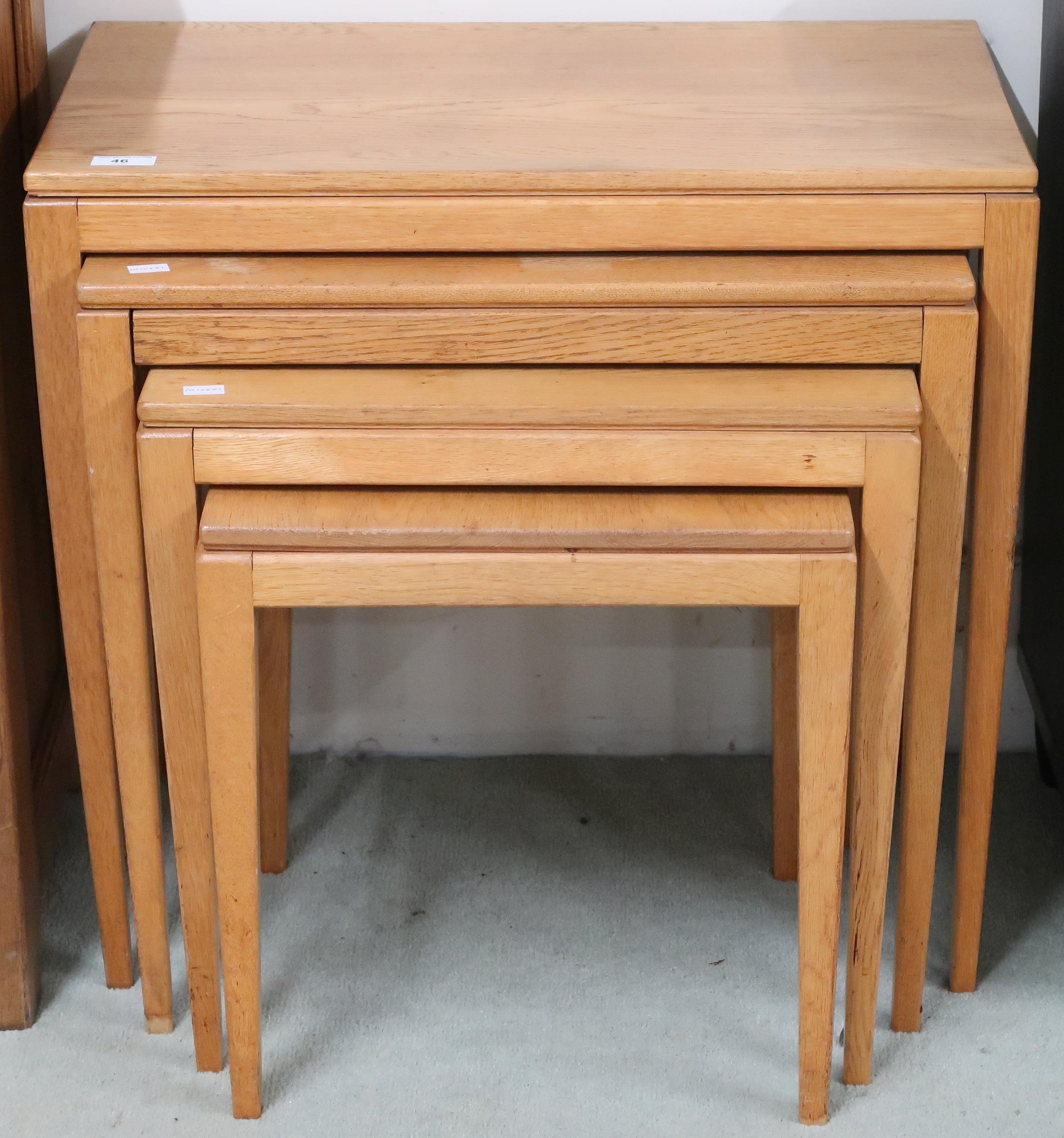 A 20th century blonde oak nest of four tables on square tapering supports, 56cm high x 61cm wide x