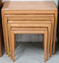 A 20th century blonde oak nest of four tables on square tapering supports, 56cm high x 61cm wide x