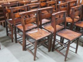 A lot of seven early 20th century elm church chairs with shaped seat on turned supports joined by