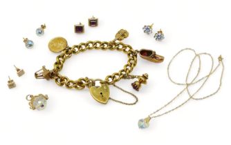 A collection of 9ct gold and yellow metal jewellery to include a gold plated charm bracelet with