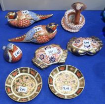 A collection of Royal Crown Derby paperweights including two pheasants, two crabs, and a robin,