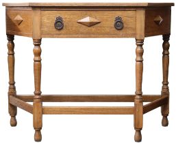 An early 20th century oak single drawer hall table with angled top with single frieze drawer on
