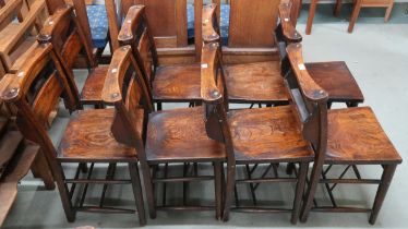 A lot of eight early 20th century elm church chairs with shaped seat on turned supports joined by
