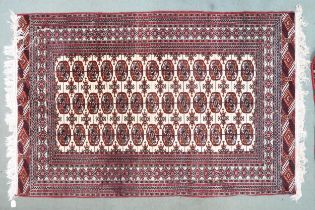 A cream ground Bokhara rug with lozenge patterned ground and multicoloured borders, 199cm long x