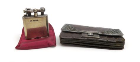 An Edwardian silver lighter, London 1904, and a silver mounted ladies leather purse (2) Condition