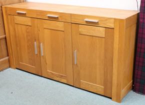 A contemporary white oak sideboard with three short drawers over three cabinet doors, 80cm high x