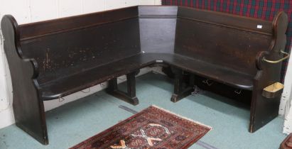 A late Victorian dark stained pine corner church pew with shaped ends one with umbrella stand mounts