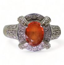 A 14ct white gold, orange gem and diamond accent ring, size N1/2, weight 4.0gms Condition Report:
