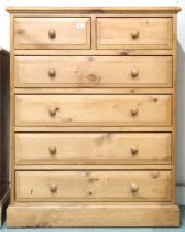 A contemporary pine chest of drawers with two short over four long drawers on plinth base, 117cm