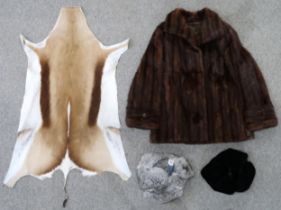 A Russian fur hat, a fur coat, a animal pelt and another Russian hat Condition Report:Available upon