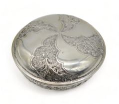 A stamped 800 white metal bowl and cover, with alternating panels of embossed foliage, 18cm