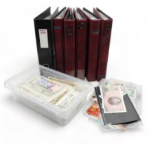 A collection of worldwide bank notes in six albums and a container of loose banknotes (6)