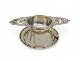 A silver tea strainer and stand, by Walker & Hall, Sheffield 1954,the lugs with openwork, 108gms