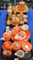 A collection of orange and orange lustre tea and coffee wares including Carlton Ware,