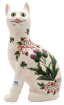 A Griselda Hill Wemyss model of a cat, decorated with thistles, clover and dog roses with green