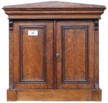 A late Victorian oak architectural style collectors cabinet with pair of cabinet doors concealing