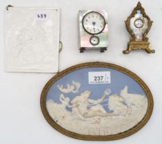 A German miniature mother of pearl mounted alarm clock, a French gilt metal and enamel miniature